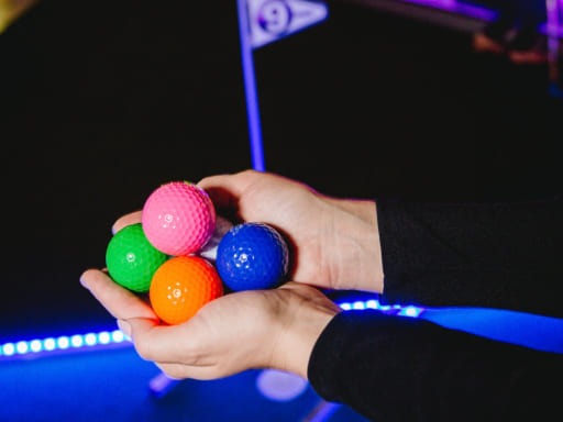 colorful golf balls and glow course Mini Golf Go